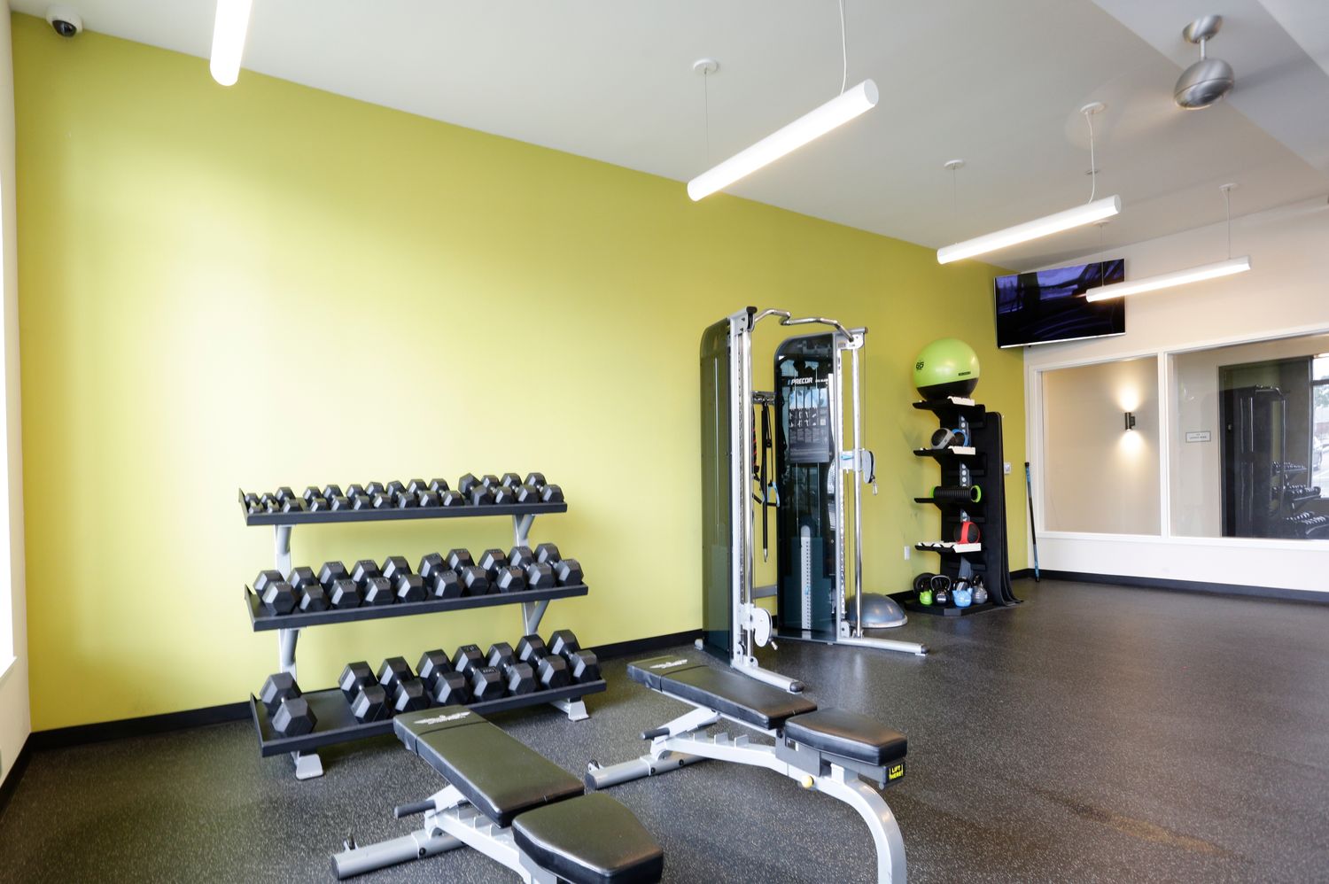 Gym with weight racks and treadmill